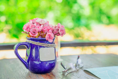 Pink flowers in purple vases on the living table on the front porch on holiday.の写真素材