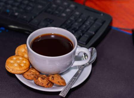 Afternoon favorite cup of coffee in front of the deskの写真素材