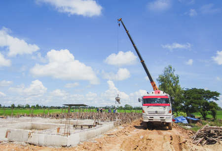 The crane lifts the cement from the mill to pour the beam.