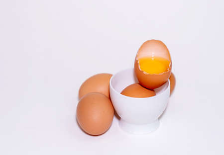 Fresh chicken eggs and yolk in the shell on isolater white background.の写真素材