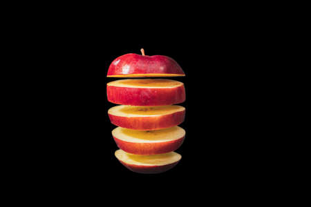 Sliced Red Apple Floating Isolated On black Background.の写真素材