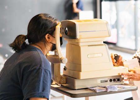 Women are taking visual acuity measurements at their annual health check.