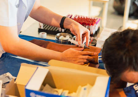 The man was afraid of taking blood samples, dared not look at the syringe.の写真素材