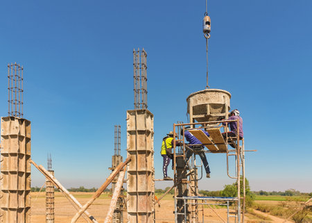The workers made a cement pole in construction site.の写真素材