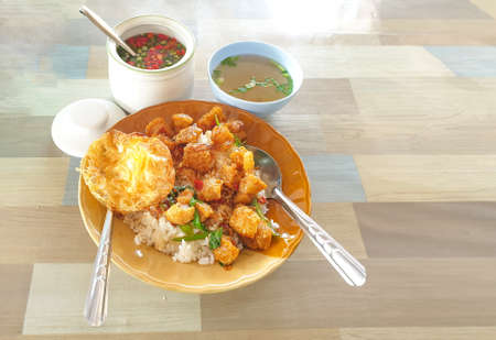 Basil fried rice, pork crackling, fried egg, delicious meal of office workers.の写真素材