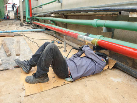 A technician is welding a fire hose in the factory.の写真素材
