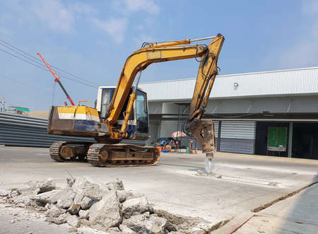 The backhoe drill the floor to make the base of the roof structure.の写真素材