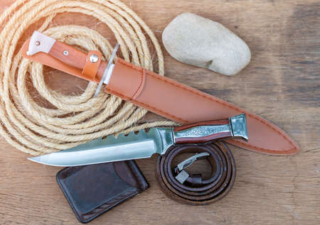 Hunting knives and trekking equipment on plank wood.の写真素材