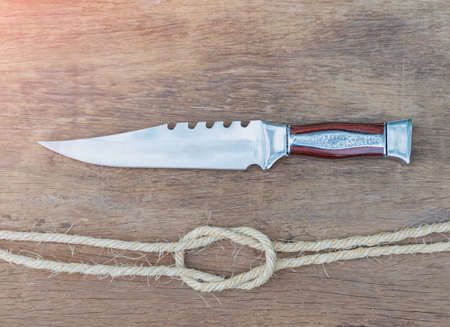 Trekking Knife and Rope, Essential Hiking Equipment on wood sheet.の写真素材