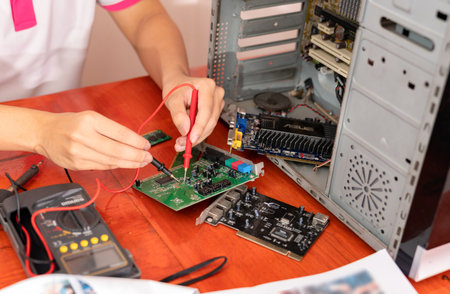 The technician use multi meter checking the computer parts for the cause.