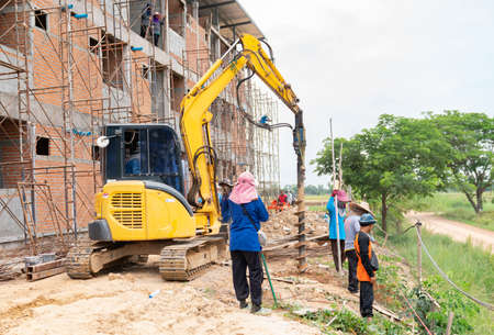 Drill excavator digger for burying fence posts around the factory.