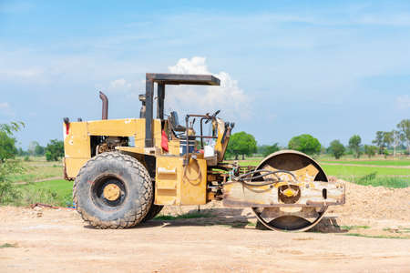 Road roller with yellow color ready to adjust the construction area.