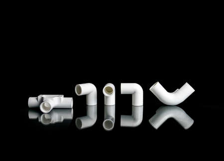 Set of plastic fittings for Electric pipeline isolated on black background.