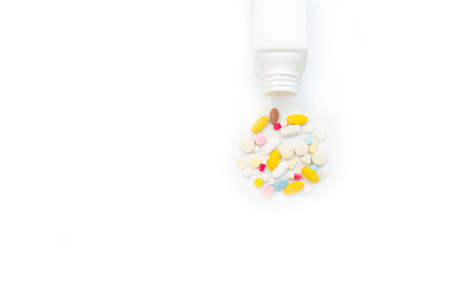 Top view bottle and scattered pills on isolate white background.の写真素材