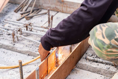 Worker welding framework prepare pour cement in factory.