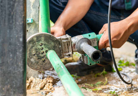 Technician use pipe welding machine connect tap water.の写真素材