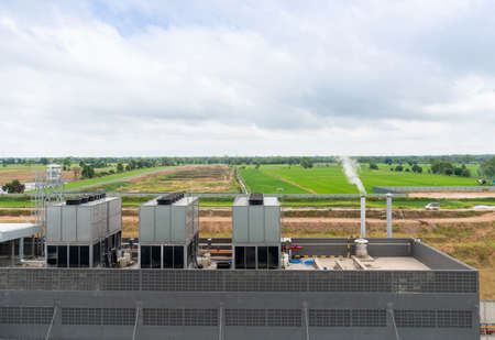 Chiller install on roof top of facility building and boiler stack blowe out smoke in factory.の写真素材