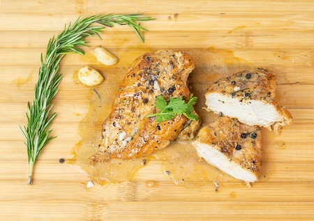 Danish-style chicken steak on wooden cutting board backgroundの写真素材