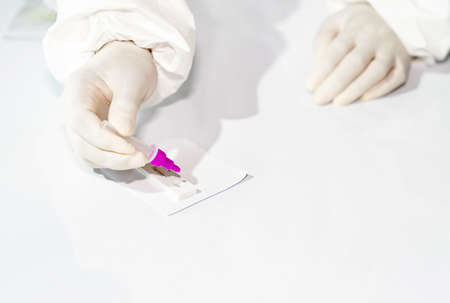 Close up Medical technicians hands drop samples on antigen test kit to detect virus