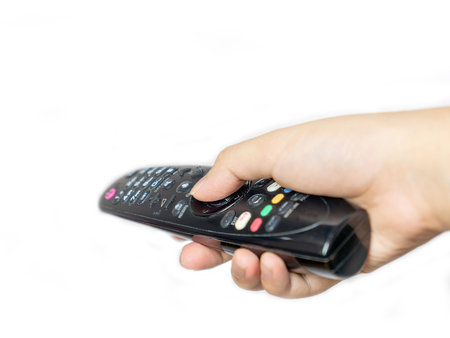 Close up the man press button on television remote control isolate white background.の写真素材
