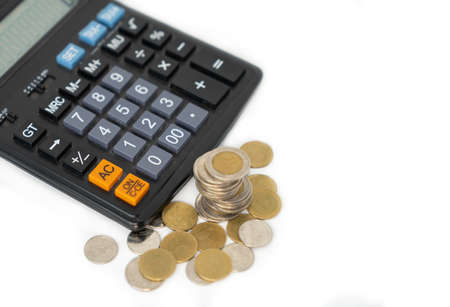 Saving and investment concept with caculator and money coin on isolate white background.の写真素材