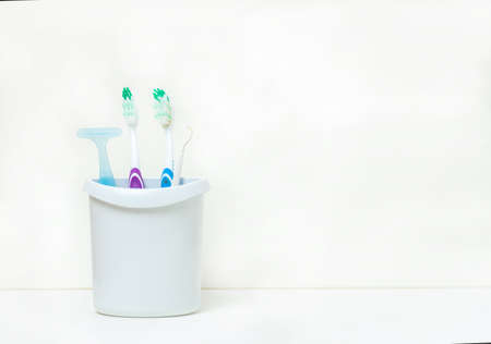 toothbrushes and tooth accessory in white mug on white backgroundの写真素材