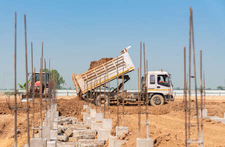 Dump truck unloads soil for the construction of foundation pile cap. Create building.の写真素材