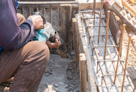 Worker use demolition hammer drill beam framework for pull out.の写真素材