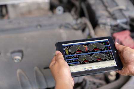 Technician diagnostics of code failure with tablet in the auto repair garageの写真素材