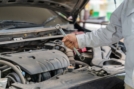 Car technician holding the wrench promt to fixed. Fixed car concept.の写真素材