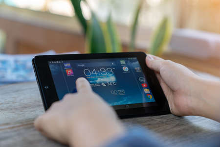 The man watching tablet to search content online in front yard.の写真素材
