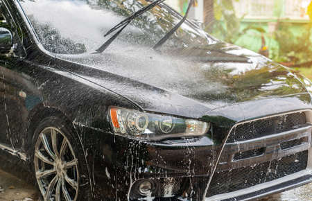 Close-Up Of Water Sprey car washing at home. Car detailing concept.の写真素材