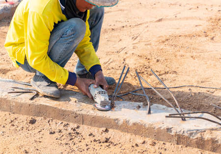 Worker don't wear gloves use grinder cut metal stick unsafe act working in construction site.
