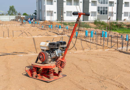 Plate compactor on sand at a construction site for adjust smooth ground.の写真素材