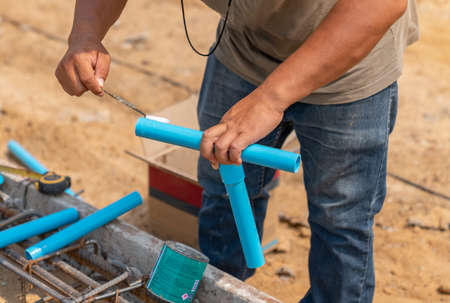 Workers glue pipes and fittings in plumbing of building. plumbing tab water.の写真素材