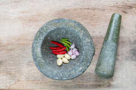 Prepare ingredient inside the stone mortar and grinding for spicy food. Top view.の写真素材