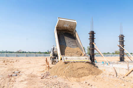 A truck pours sand onto a construction site. Ingredient cement.の写真素材