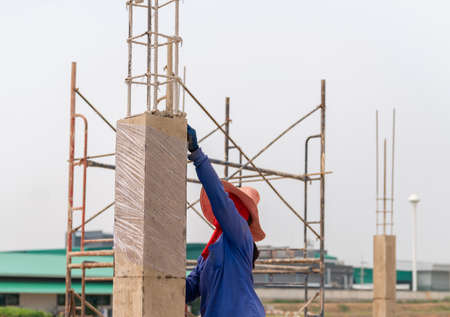 Reinforced concrete piles of the new building with clear plastic wrap for keeping the moisture in pole for strong and durableの写真素材