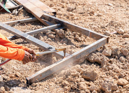 Worker cutting steel frame without gloves. non safety.の写真素材