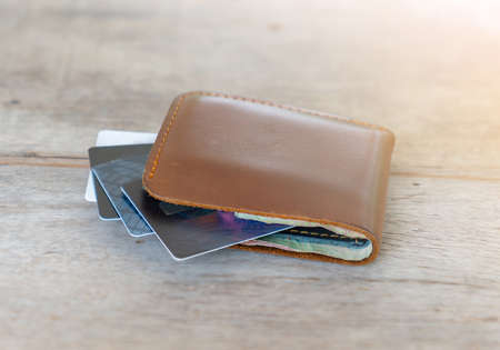 Wallet with credit cards on wooden background. Economic and finance concept.