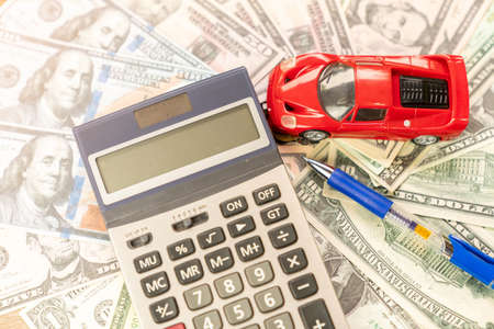 Model car and caculator on dollar bills concept of car finance and leasing.の写真素材