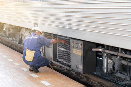 Techician water spray train radiator for reduce temperature after stop in station.の写真素材