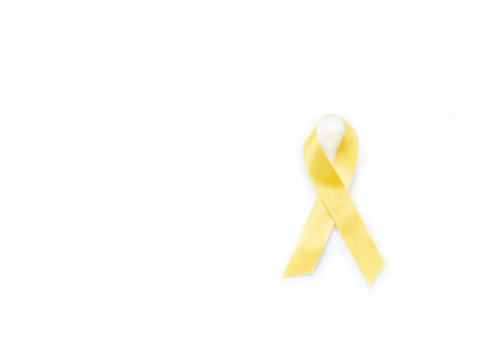 Yellow awareness ribbon on isolate white background for bone cancer and troops support symbol.の写真素材