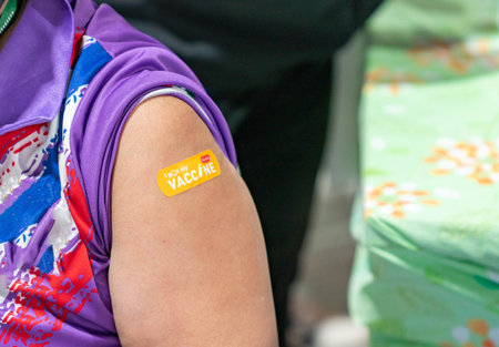 Woman with I got my COVID-19 vaccine sticker. after inject vaccine.