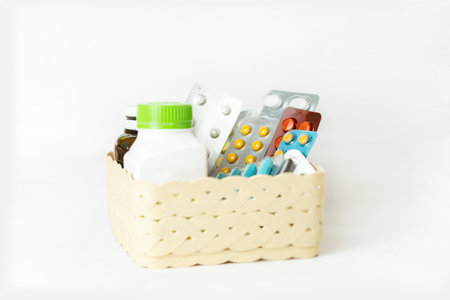 Various capsules, pack of medicines in basket with medicine bottle on a white background. Medicine and Pill concept.の写真素材