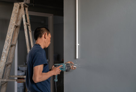 Technical use electric drill wall for plug and switch box in building site.の写真素材
