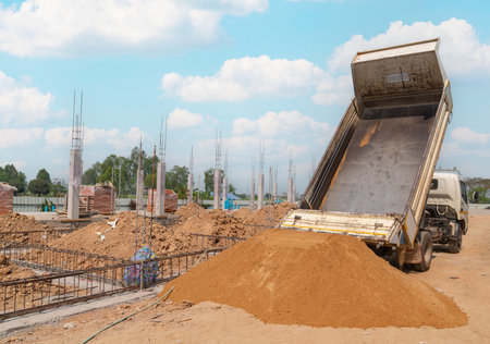 Truck dumping and tipping sand for new building and blue sky.の写真素材