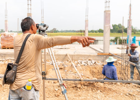 Surveyor's telescope looking for marking ground floor level at constructions site.の写真素材