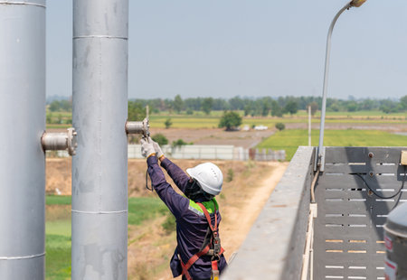 Environment officer remove nut on cover hole stack for sampling air monitoring in factory.の写真素材