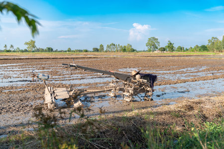 Farmer relax during day and park plow tractor in the rice field.の写真素材